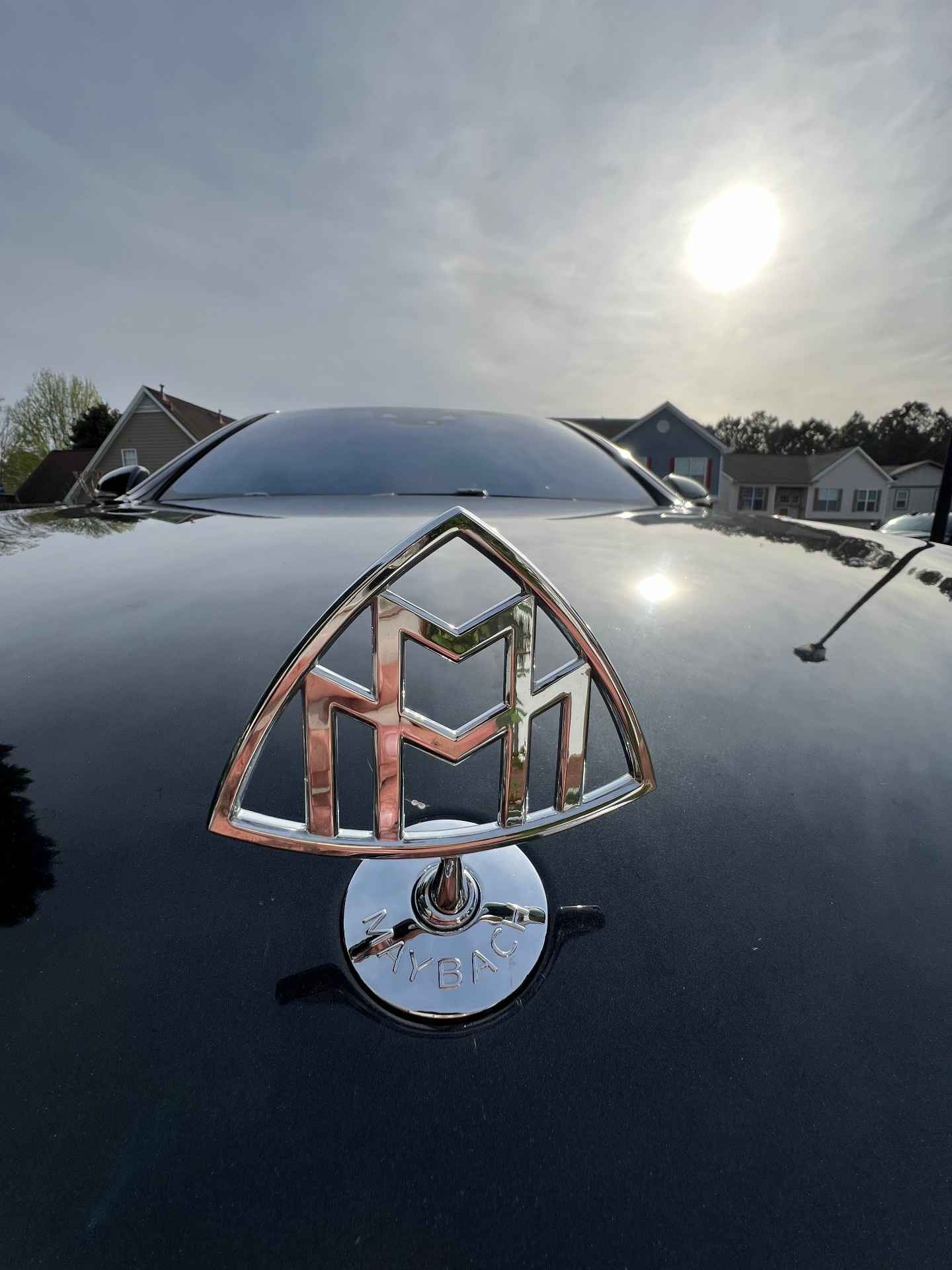 Reflection on the polished hood of a Mercedes-Maybach